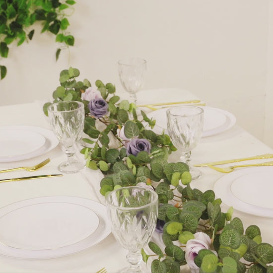 6ft artificial eucalyptus garland with lavender silk roses on a table setting.