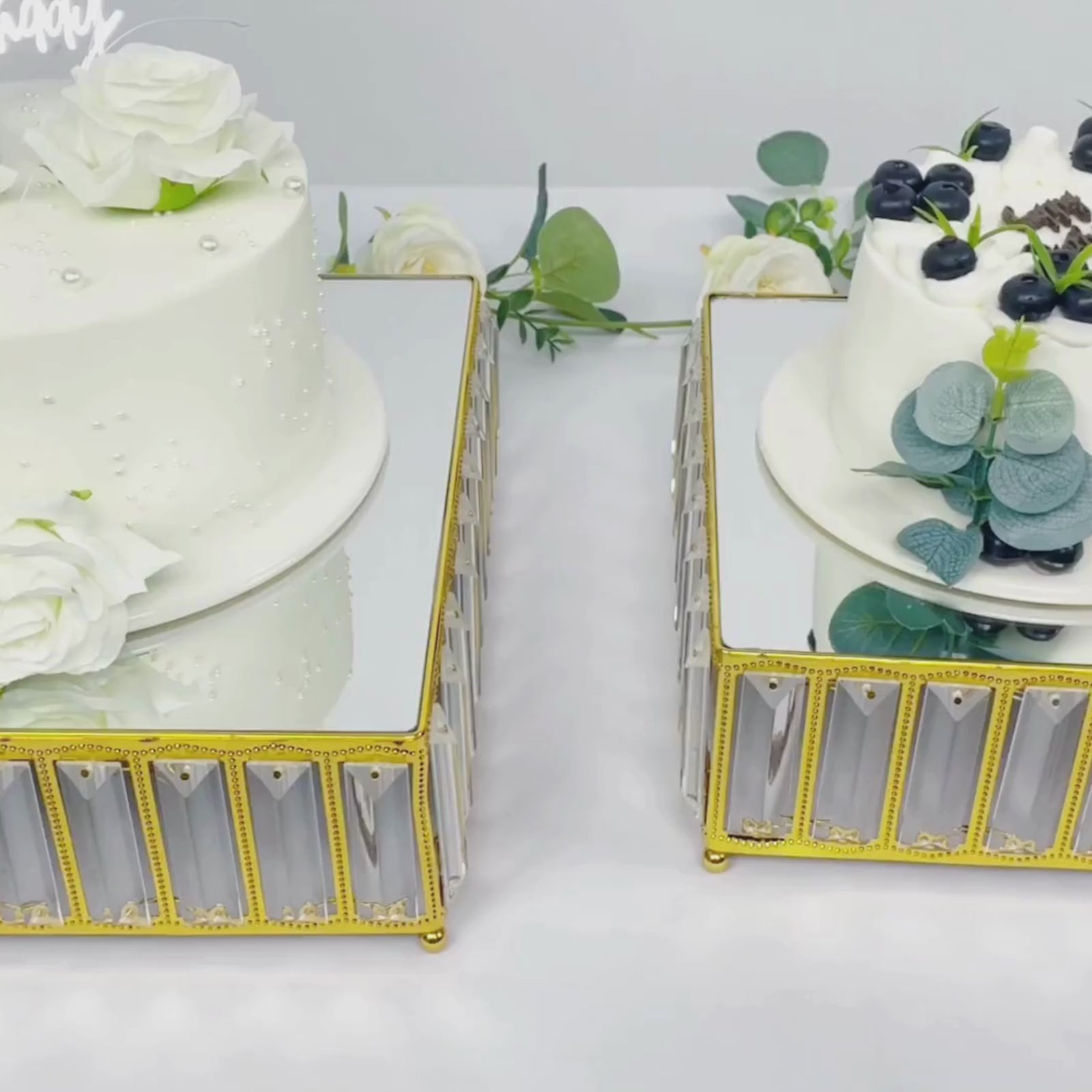 Gold metal crystal pendant cake stands with mirror tops, stackable dessert trays.