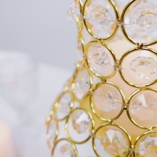 Gold crystal beaded candle holders with lamp-inspired shades.