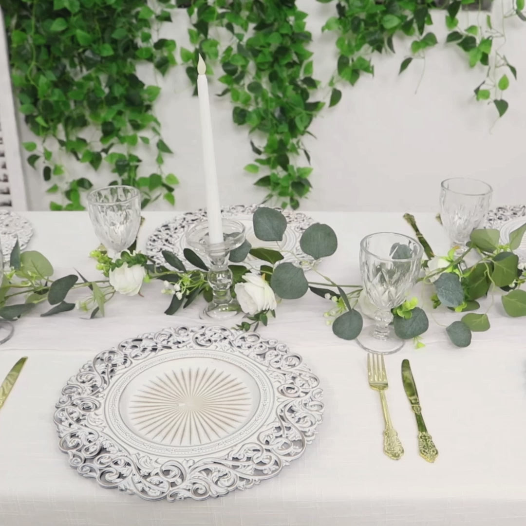 Antique white round charger plates with vintage floral carved rim.