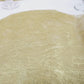Metallic gold round placemat for dining and events, 13 inches in diameter.