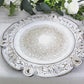 Antique white round acrylic charger plate with floral embossed scalloped rim.