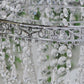 Silver beaded crystal chandelier with ornate metal frame.