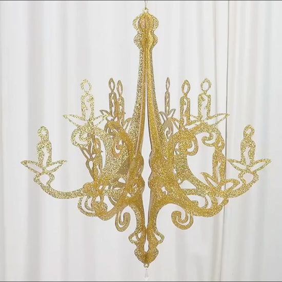Gold glittered acrylic chandelier hanging decor with 3D interlocking cutout design.