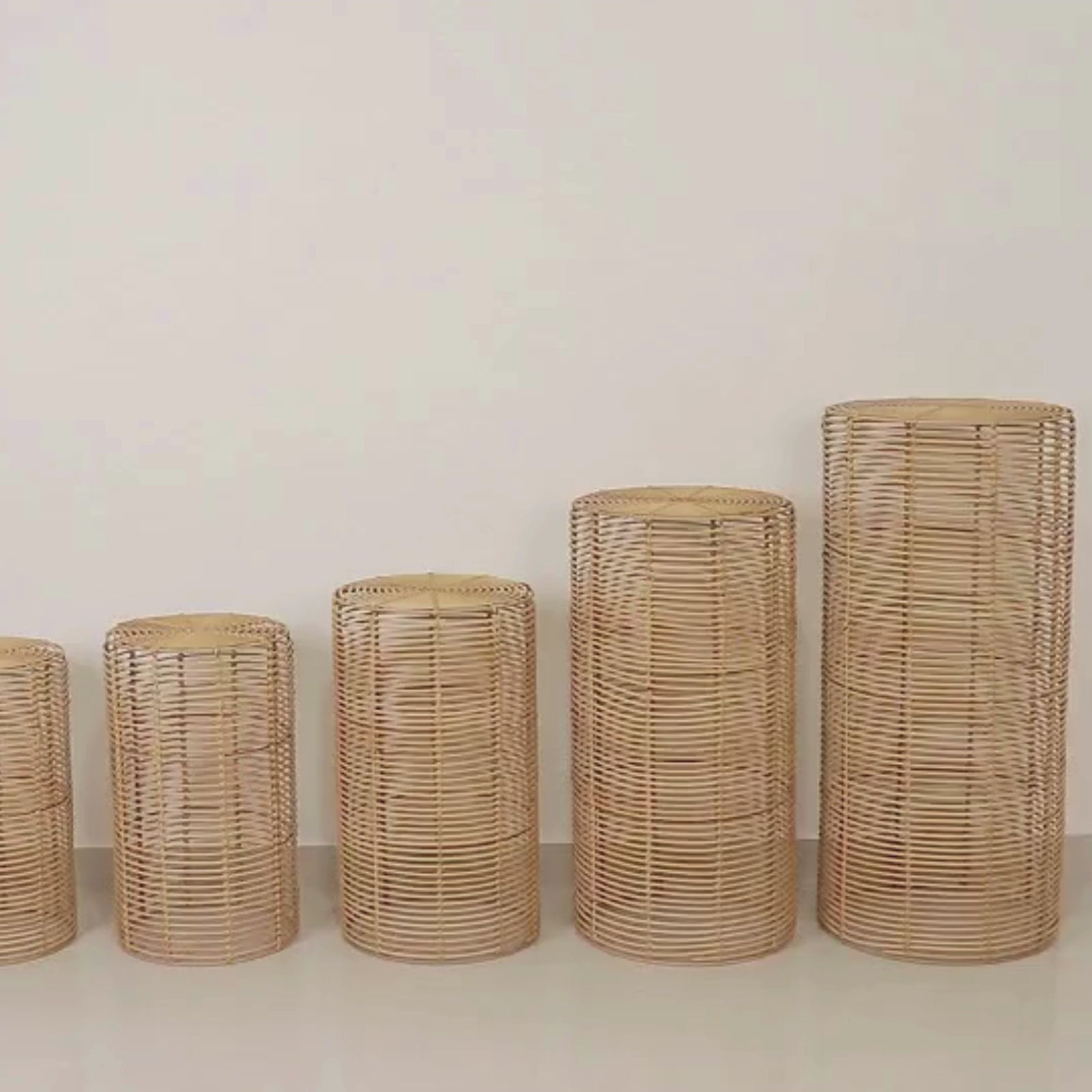 Natural woven rattan wicker pedestal stands in various heights.