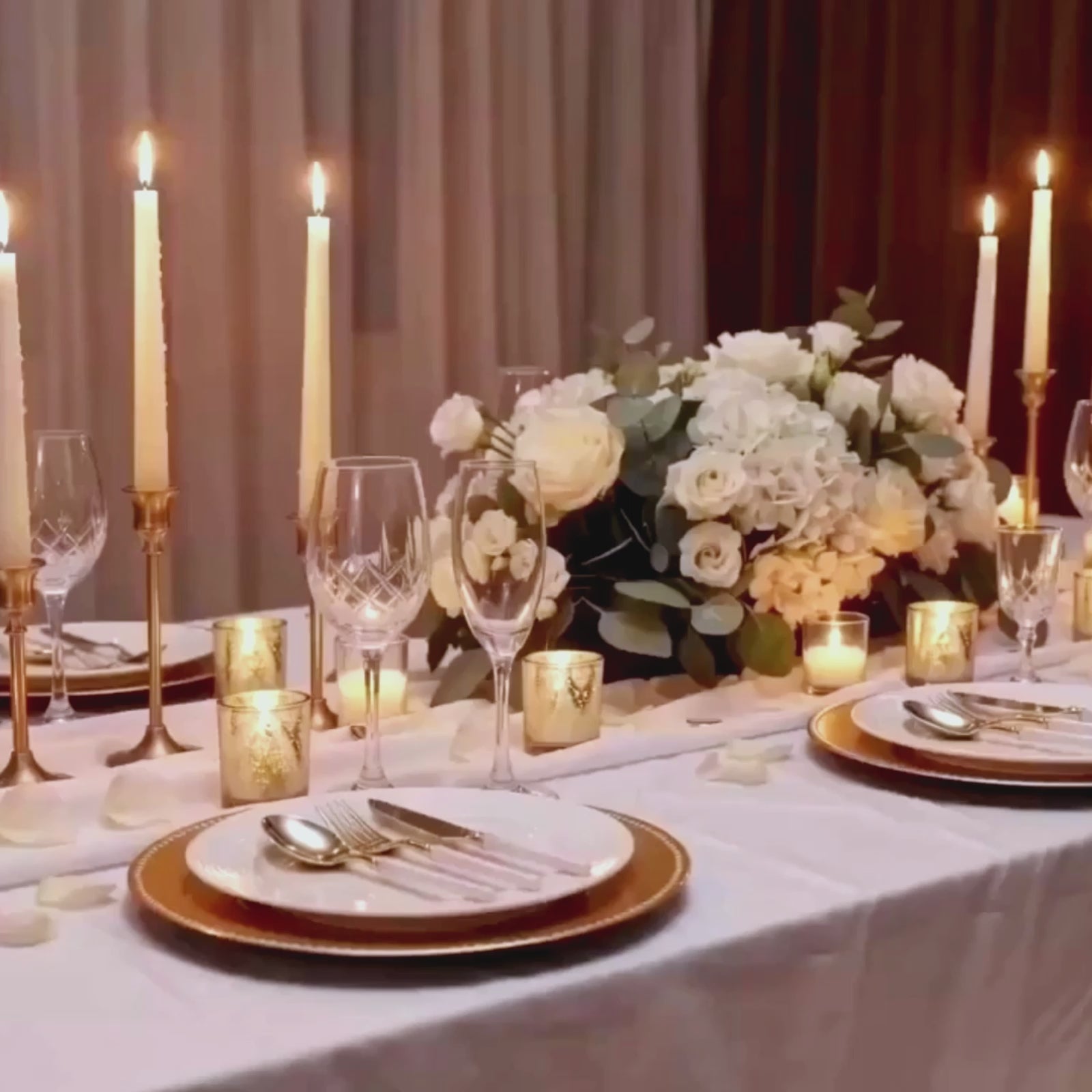 Gold plastic cutlery set with white handles on a beautifully arranged table setting.