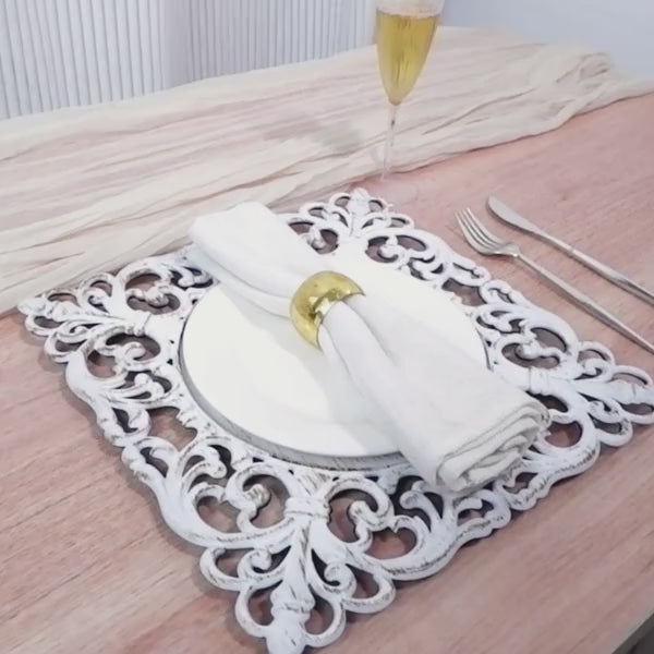 Antique white square acrylic charger plate with hollow lace border.