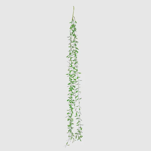 Green artificial hanging vines with weeping willow leaves for wall decor.