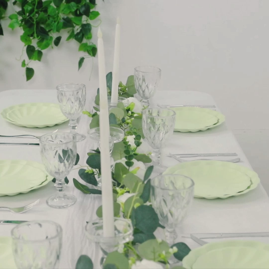 Sage green biodegradable dinner plates set on a table with elegant decor.