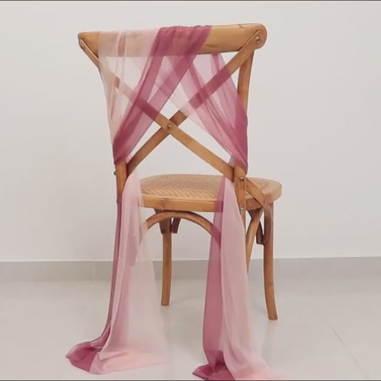 Mauve and blush sheer chair drape decor on a wooden chair.