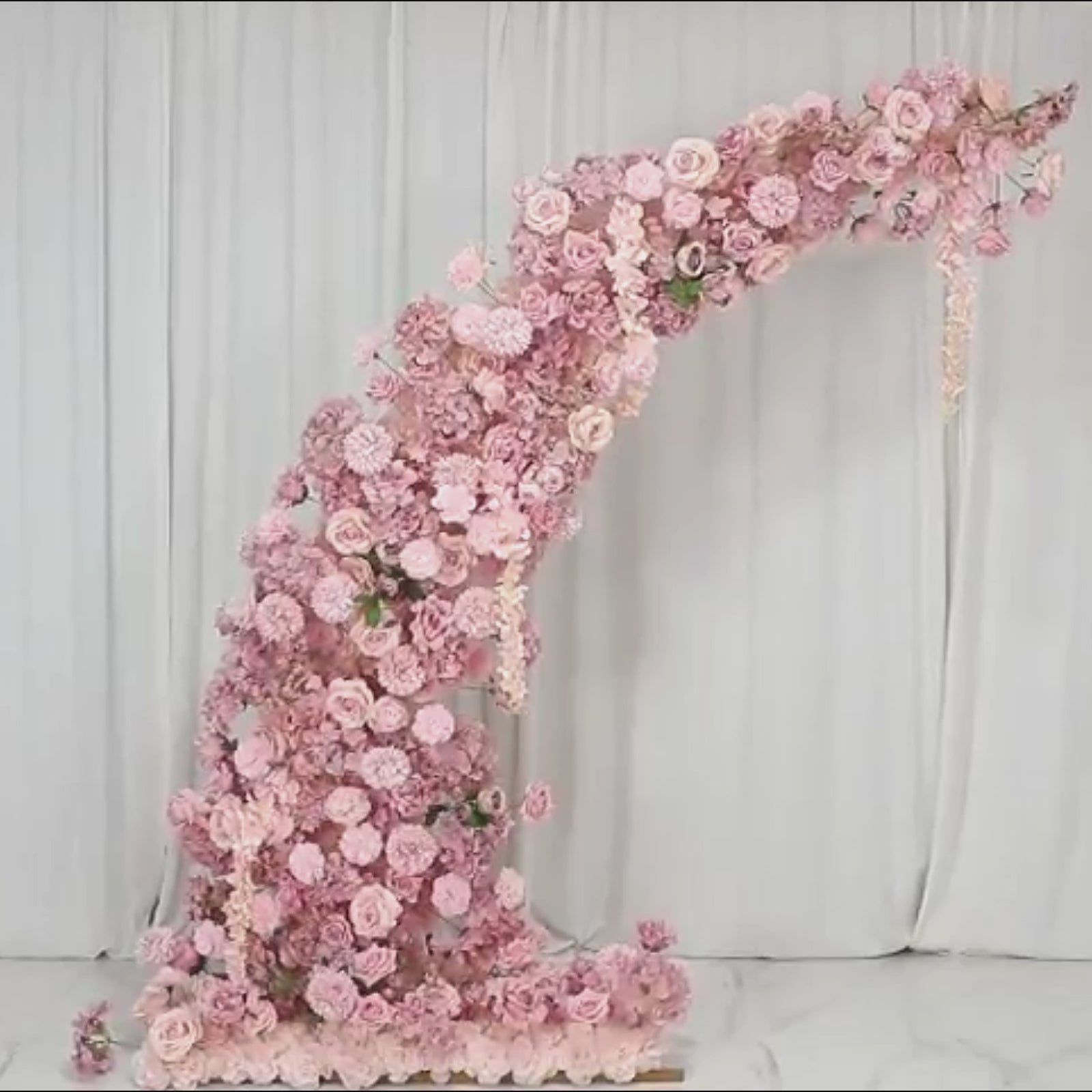 Dusty rose floral backdrop for wedding arch with roses and hydrangeas.