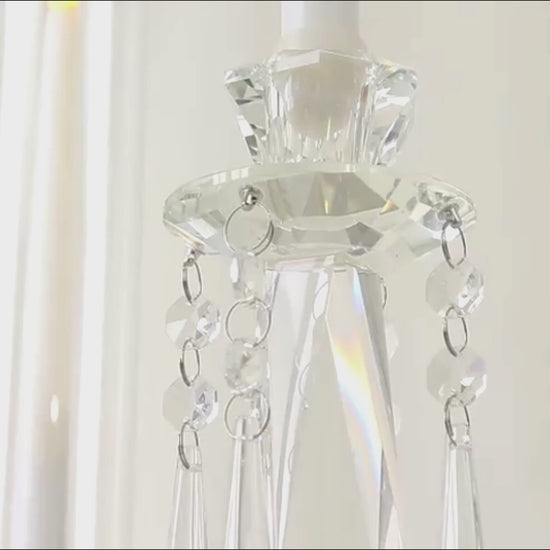 Crystal candelabra taper candle holder with elegant glass shades and hanging accents.