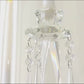 Crystal candelabra taper candle holder with elegant glass shades and hanging accents.