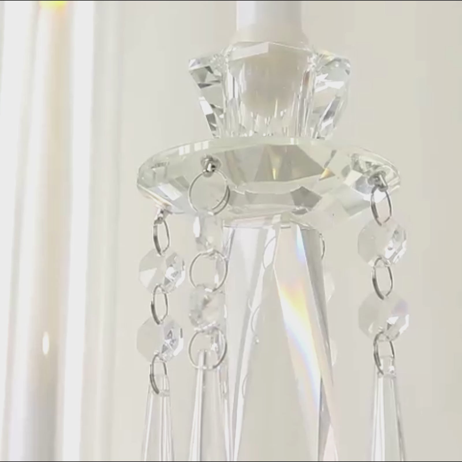 Crystal candelabra taper candle holder with elegant glass shades and hanging accents.