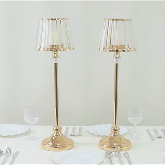 Gold crystal pendant candle holders with classic empire lamp shades.