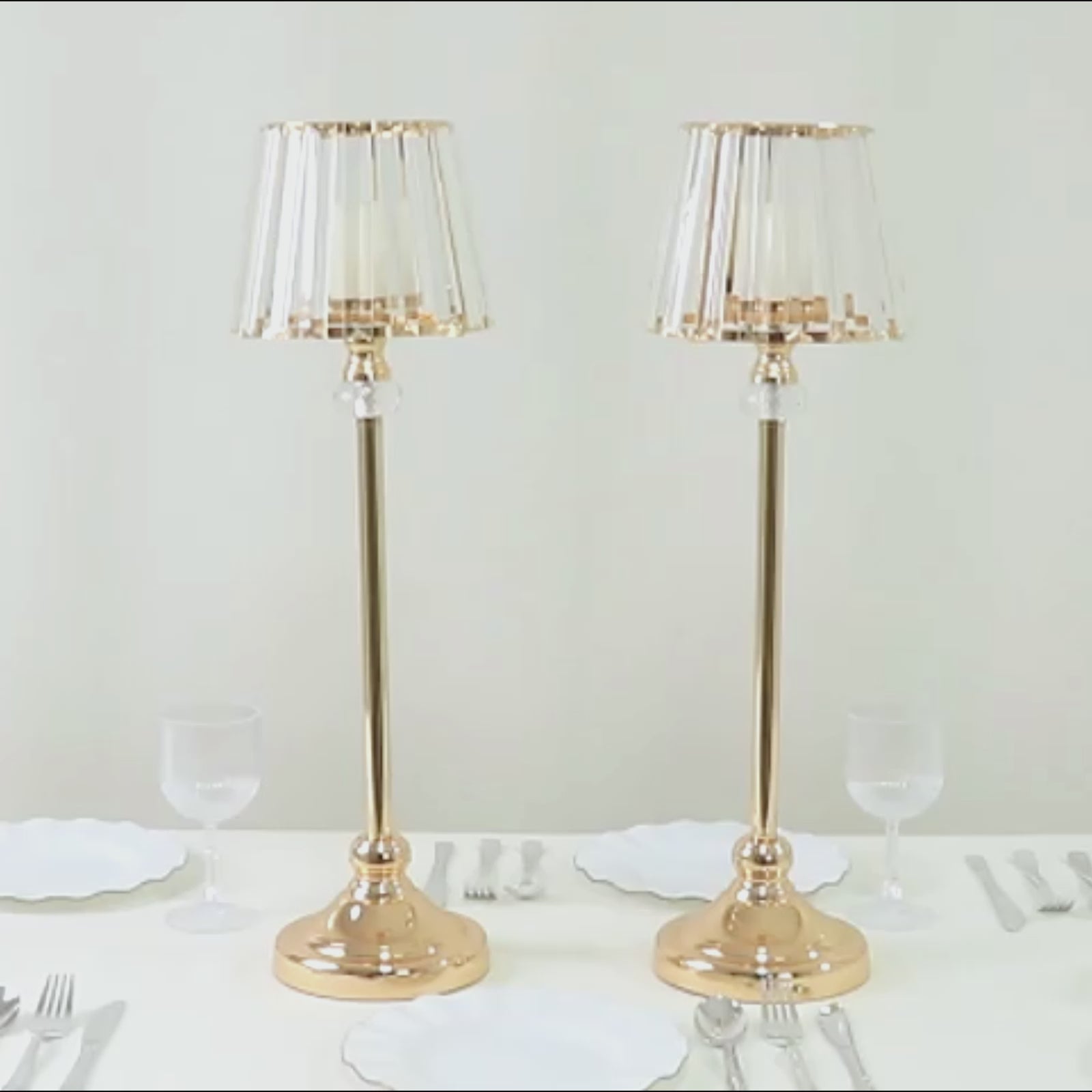 Gold crystal pendant candle holders with classic empire lamp shades.