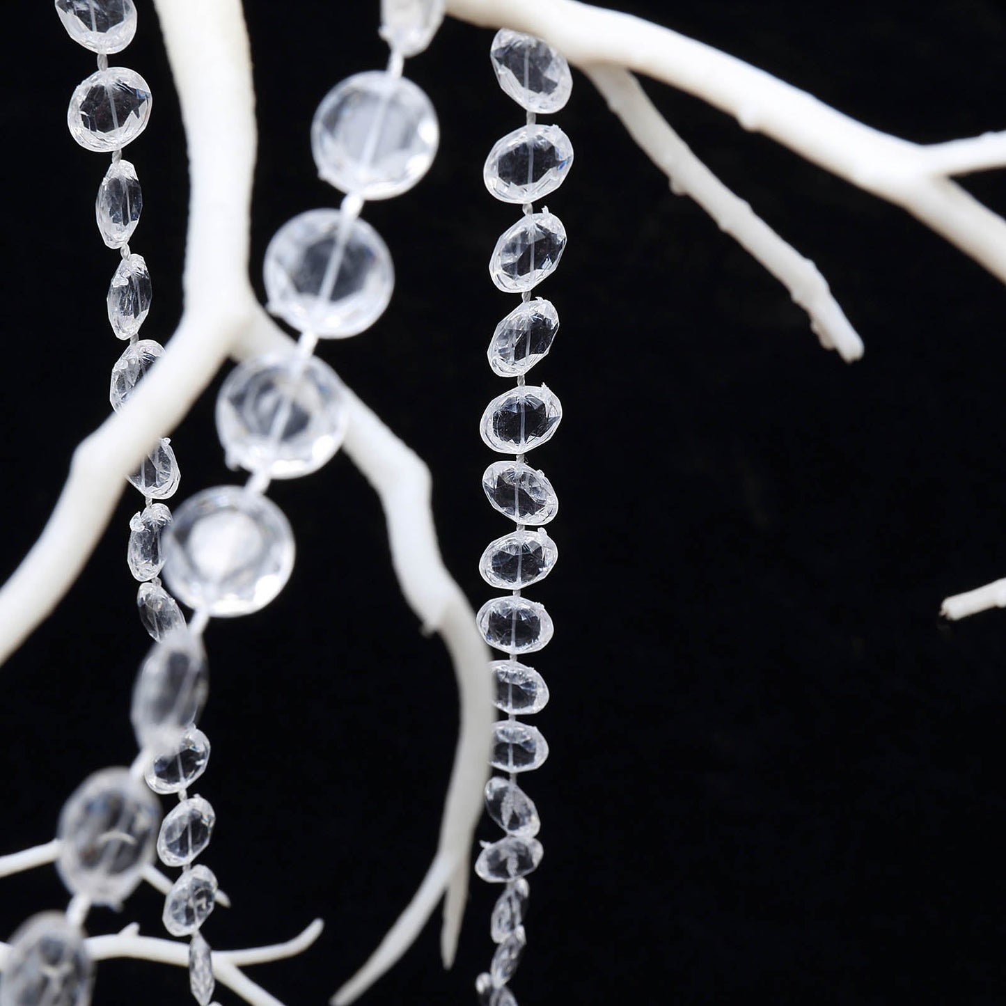 Clear acrylic crystal diamond garland chain bead roll on a decorative branch.
