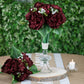Burgundy artificial silk peonies bouquet in a clear vase.