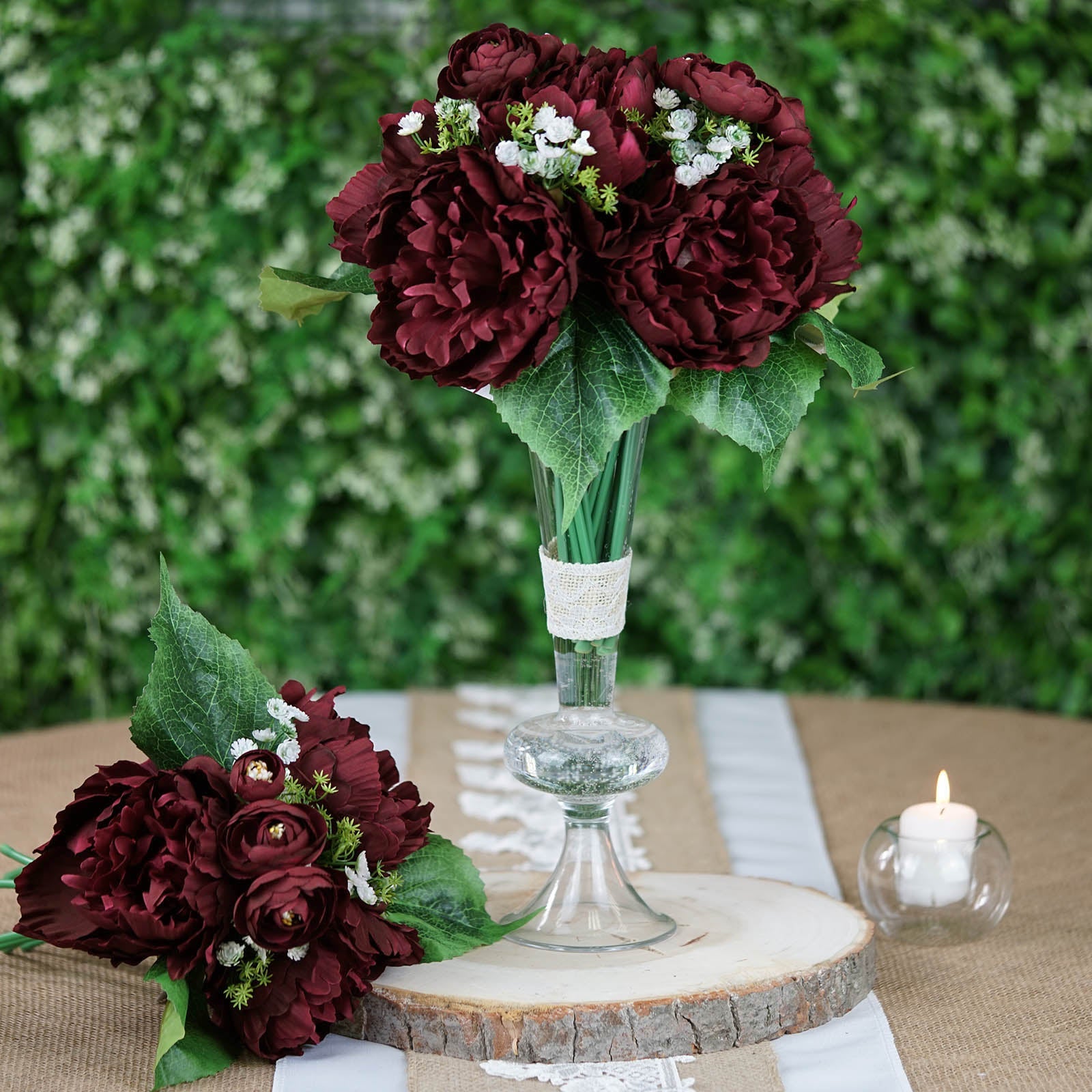 Burgundy artificial silk peonies bouquet in a clear vase.