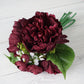 Burgundy artificial silk peonies bouquet with greenery.