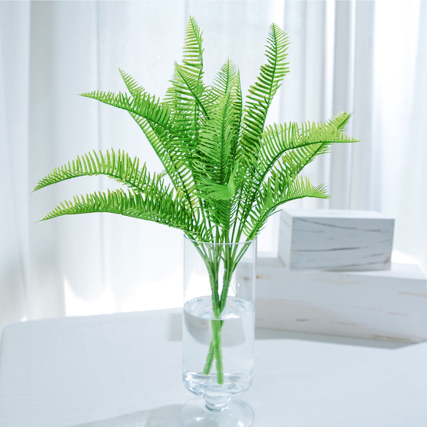 Green artificial Cycas fern leaf indoor bush with two stems.