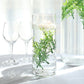 6" Mini Green Artificial Fern Leaf Branch Stems in a vase with candles.