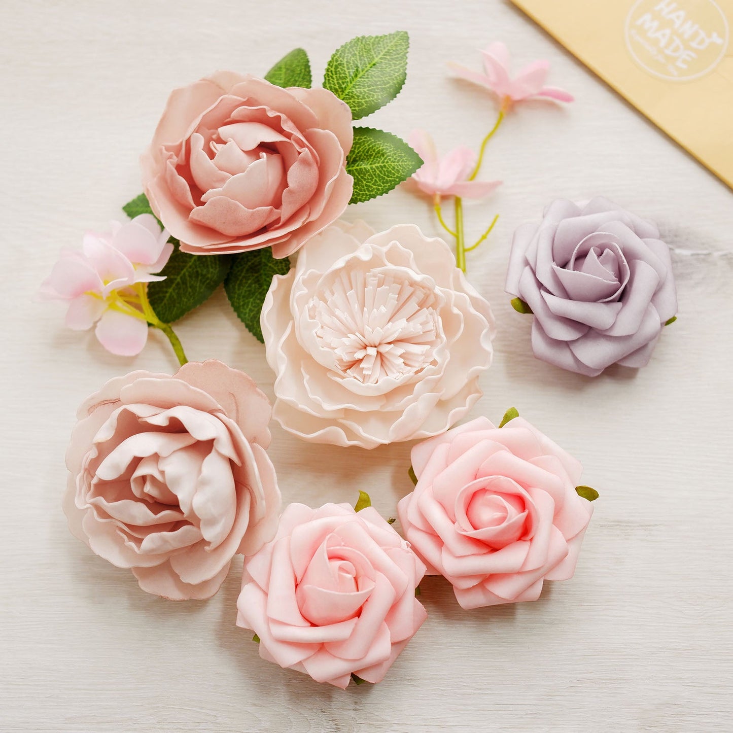 Pink and lavender artificial flower mix with peonies and roses.