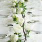 Cream artificial silk peony garland for elegant table decor.