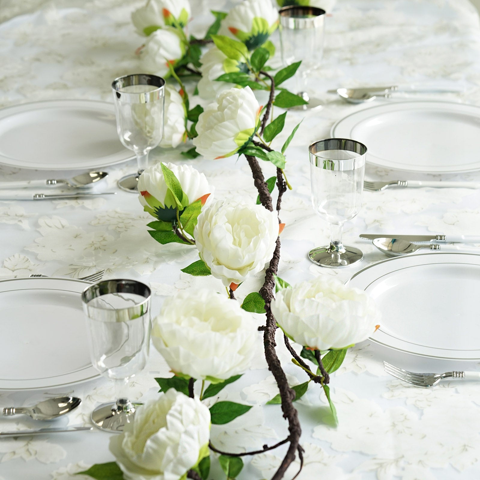 Cream artificial silk peony garland for elegant table decor.