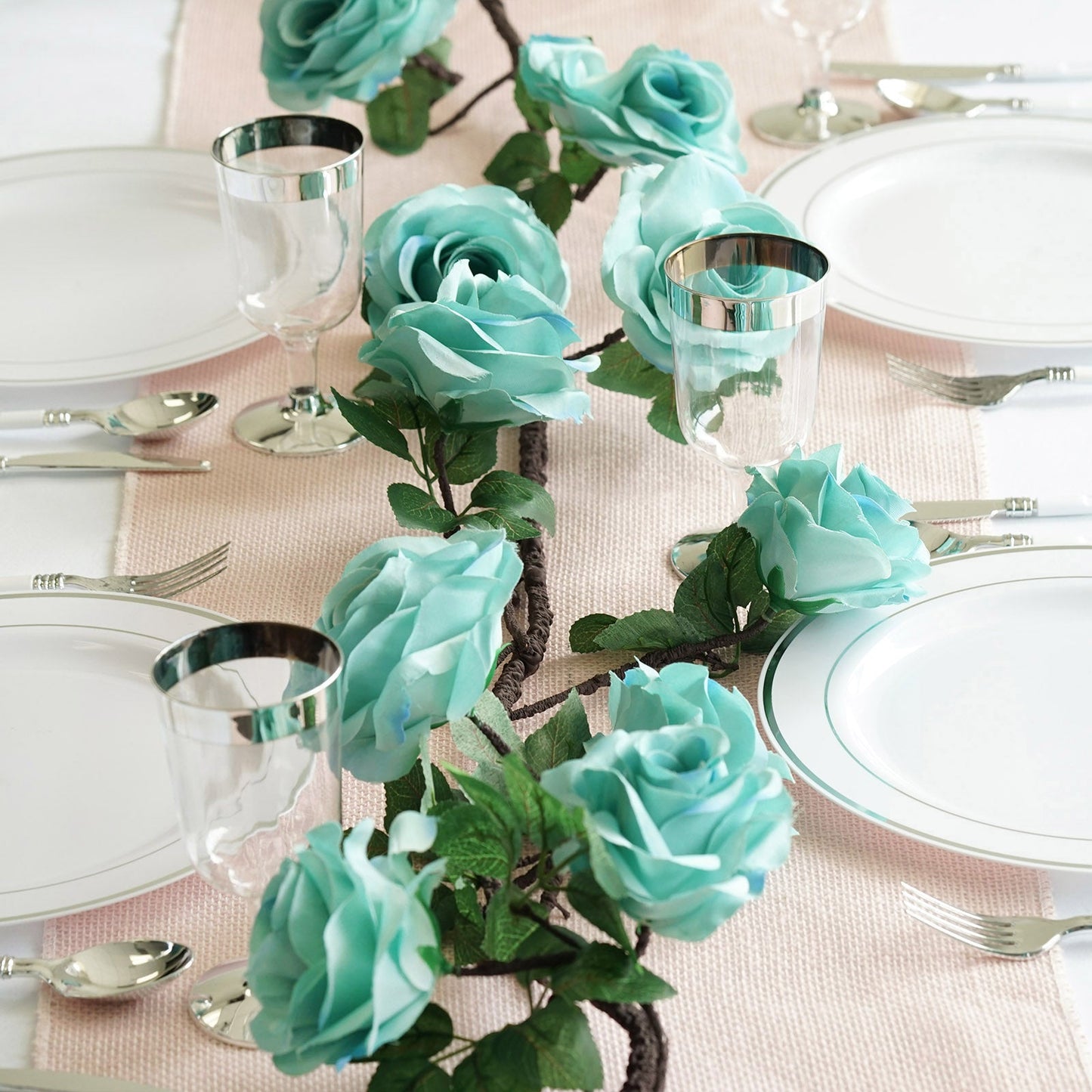 Aqua artificial silk rose hanging flower garland vine on a table setting.
