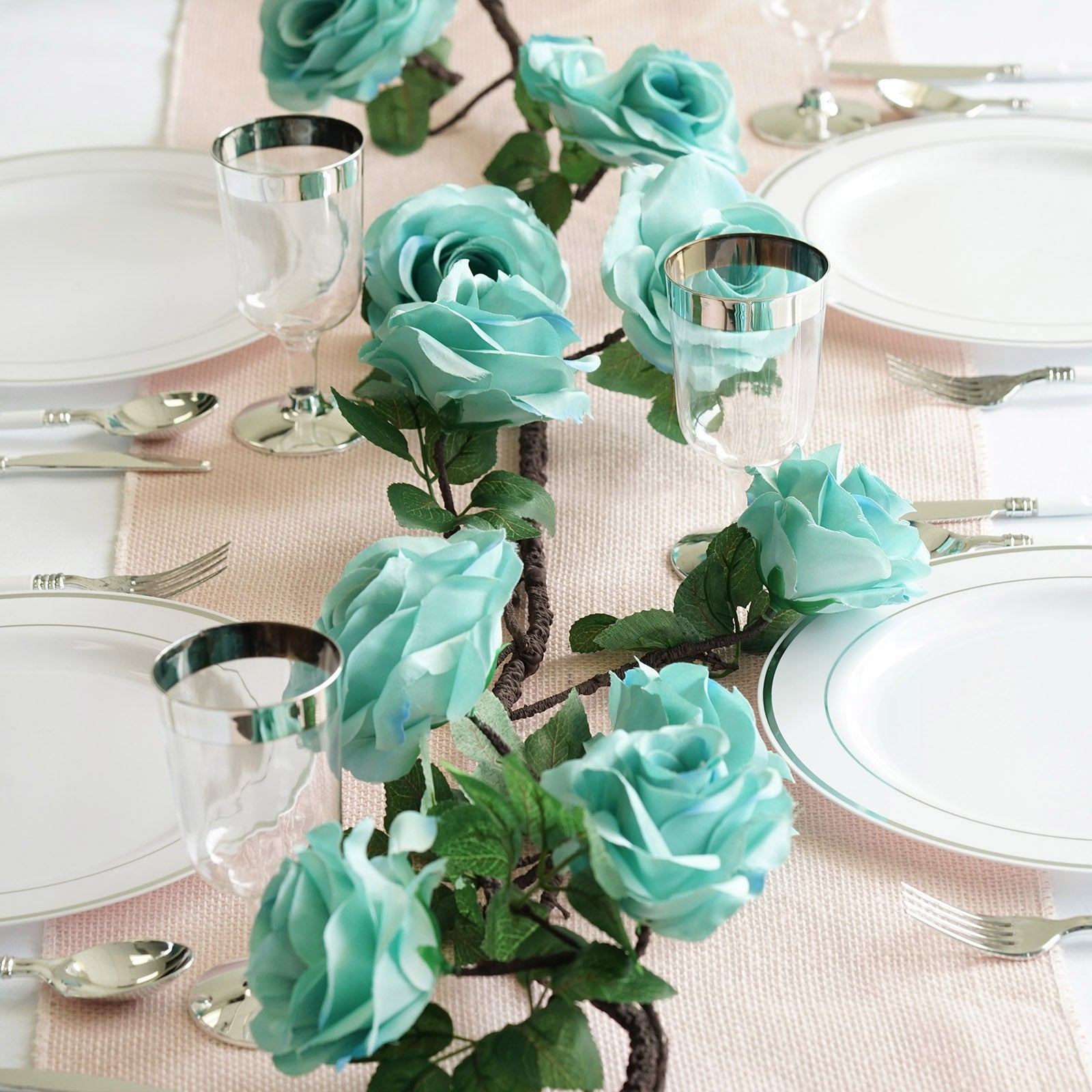 Aqua artificial silk rose hanging flower garland vine on a table setting.