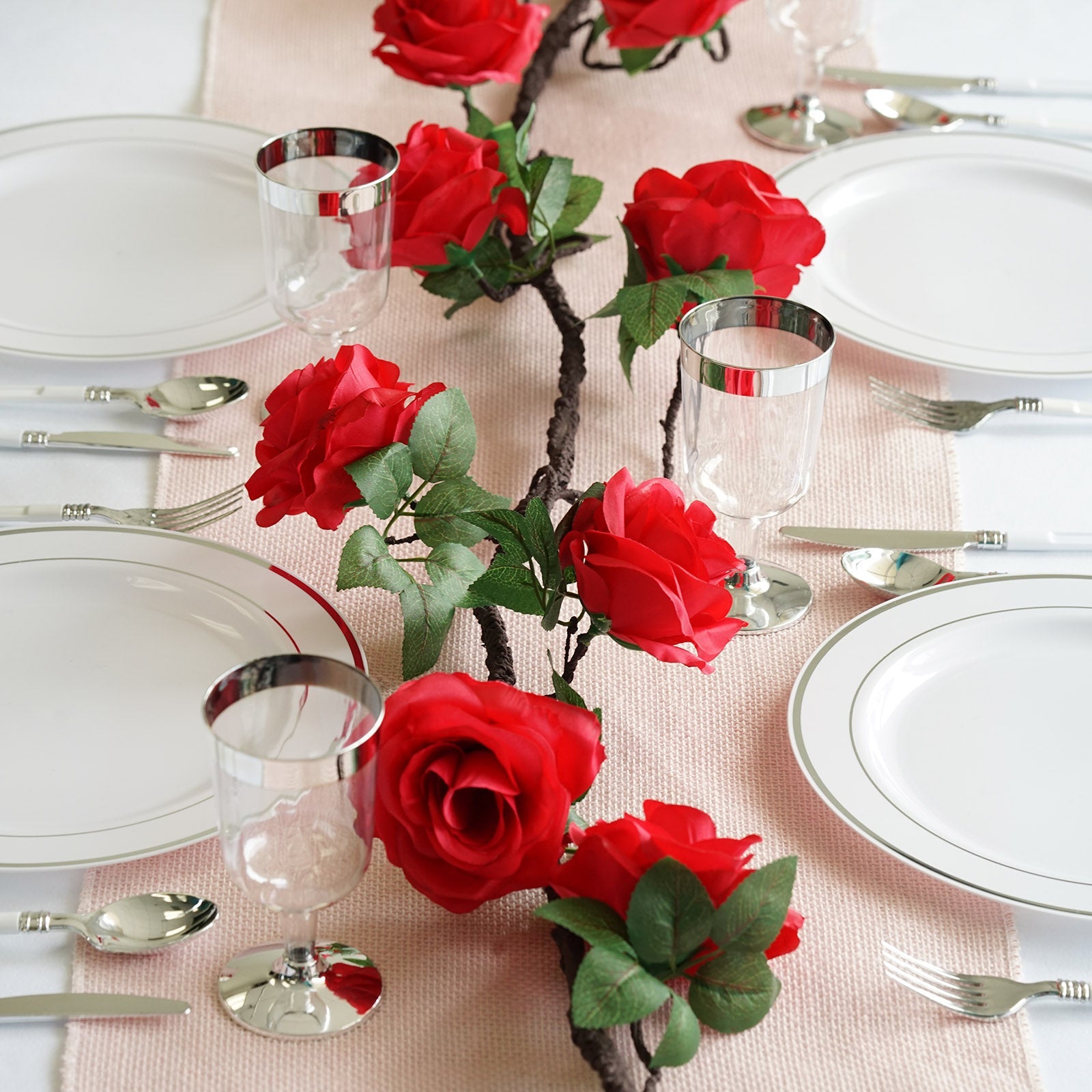 Red artificial silk rose garland for elegant table decor.