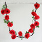 Red artificial silk rose hanging flower garland with faux vine.