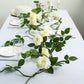 Cream artificial rose and leaf flower garland vine for elegant table decor.