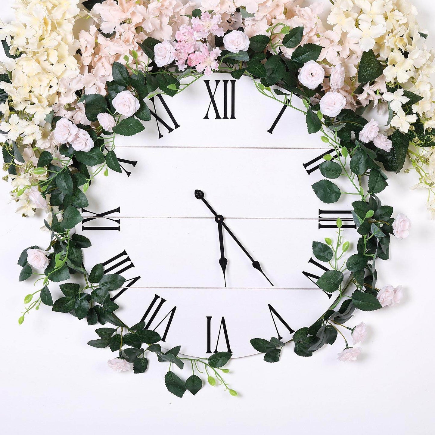 Blush artificial silk roses flower garland vine on a clock face.