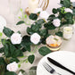 Blush artificial silk roses garland vine on table setting.