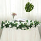 Cream artificial silk rose garland with greenery, perfect for decor.