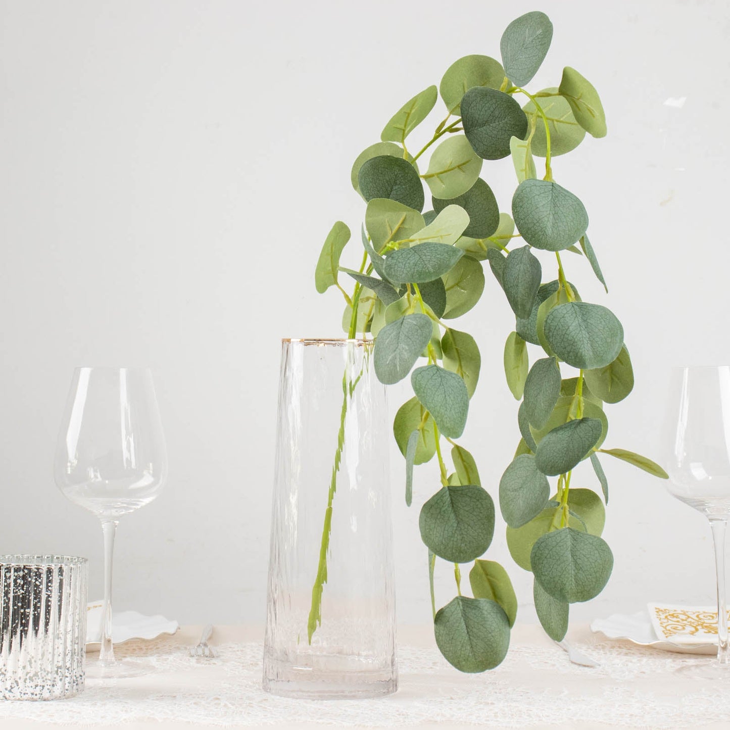 41" green real touch hanging eucalyptus stems in a clear vase.