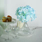 Blue artificial satin hydrangeas bouquet in a clear vase.