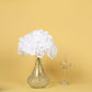 White artificial satin hydrangeas in a clear glass vase.