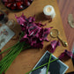 Eggplant artificial calla lily flowers in a decorative arrangement.