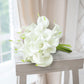White artificial calla lily flowers with green accents.