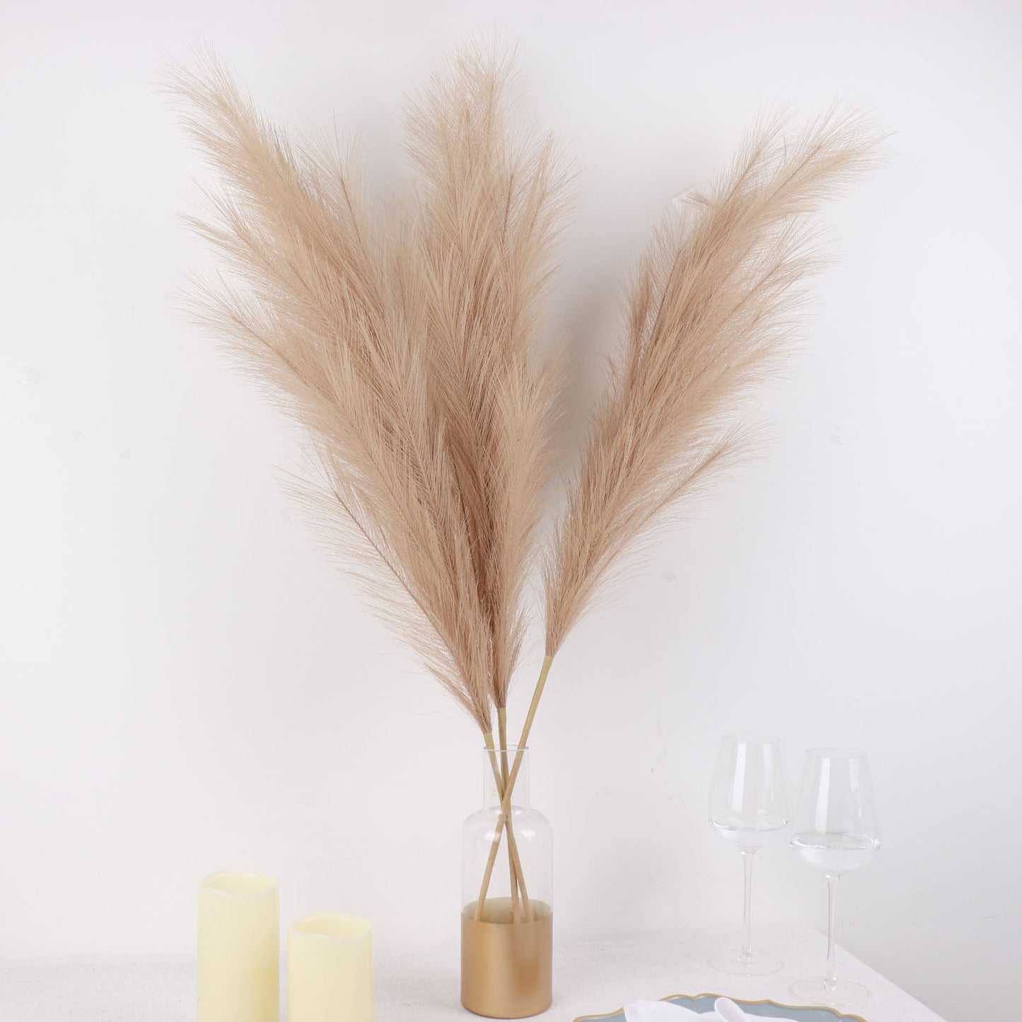 Taupe artificial pampas grass plant sprays in a vase arrangement.