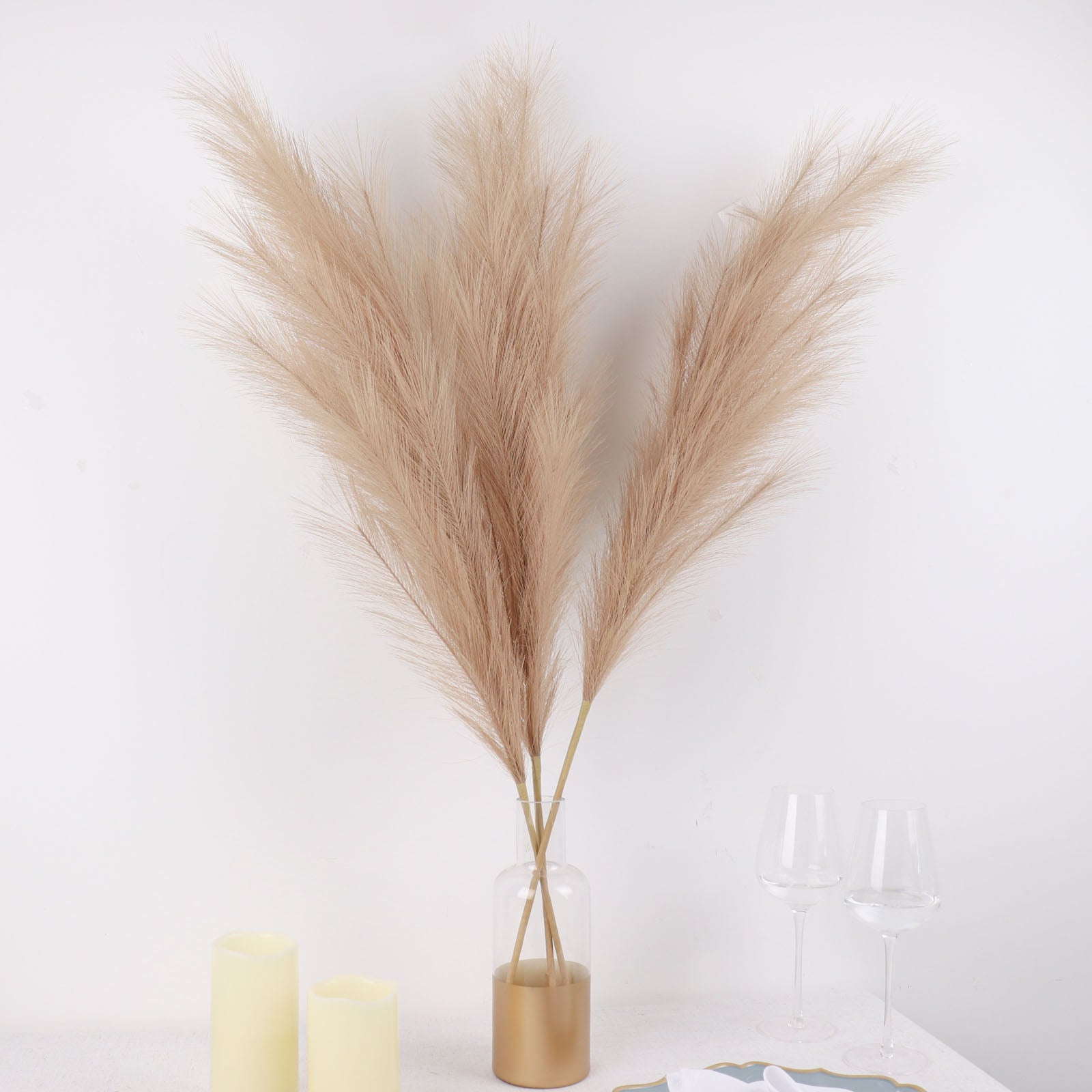 Taupe artificial pampas grass plant sprays in a vase arrangement.