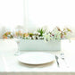 Assorted artificial aeonium spray succulent air plants in a white planter.