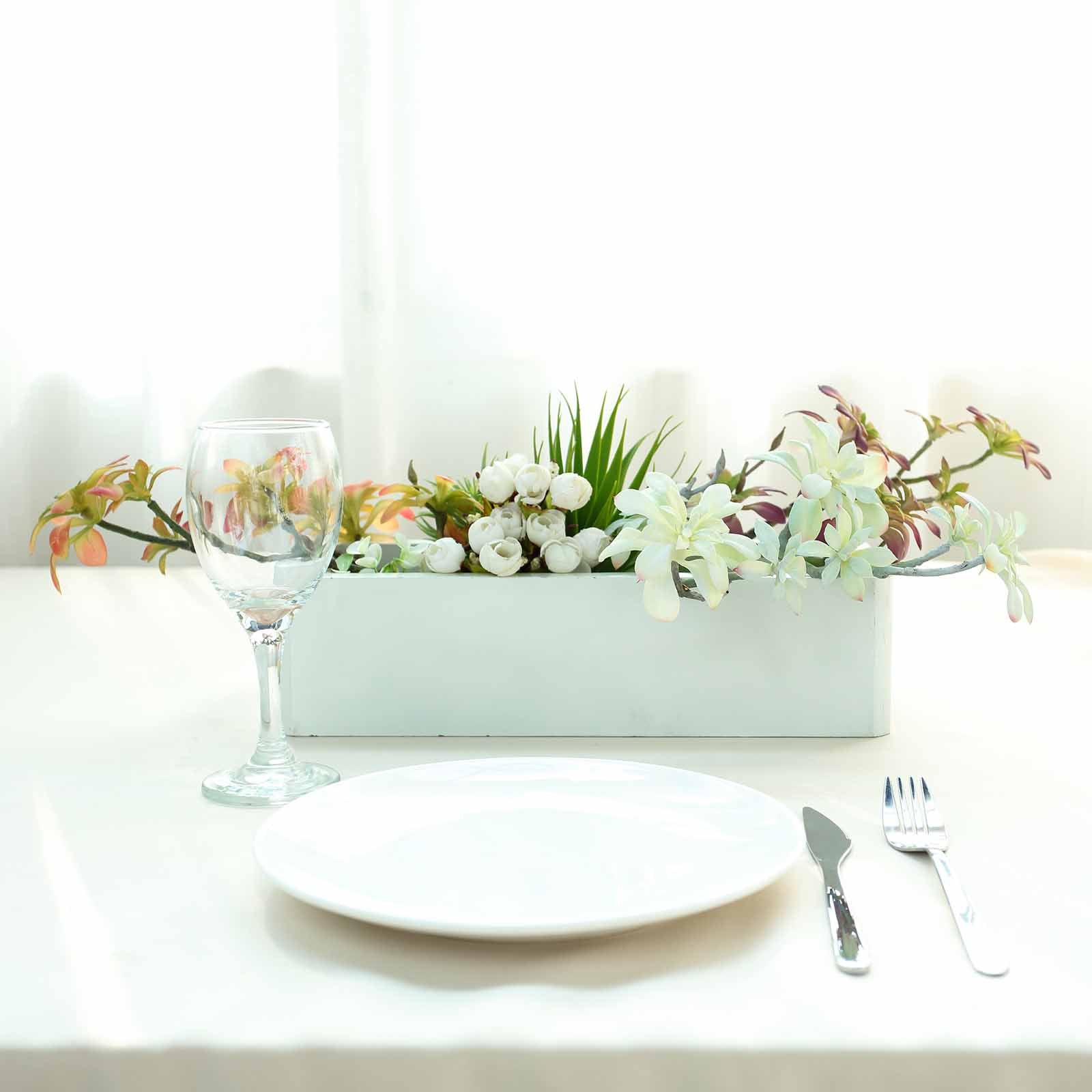 Assorted artificial aeonium spray succulent air plants in a white planter.