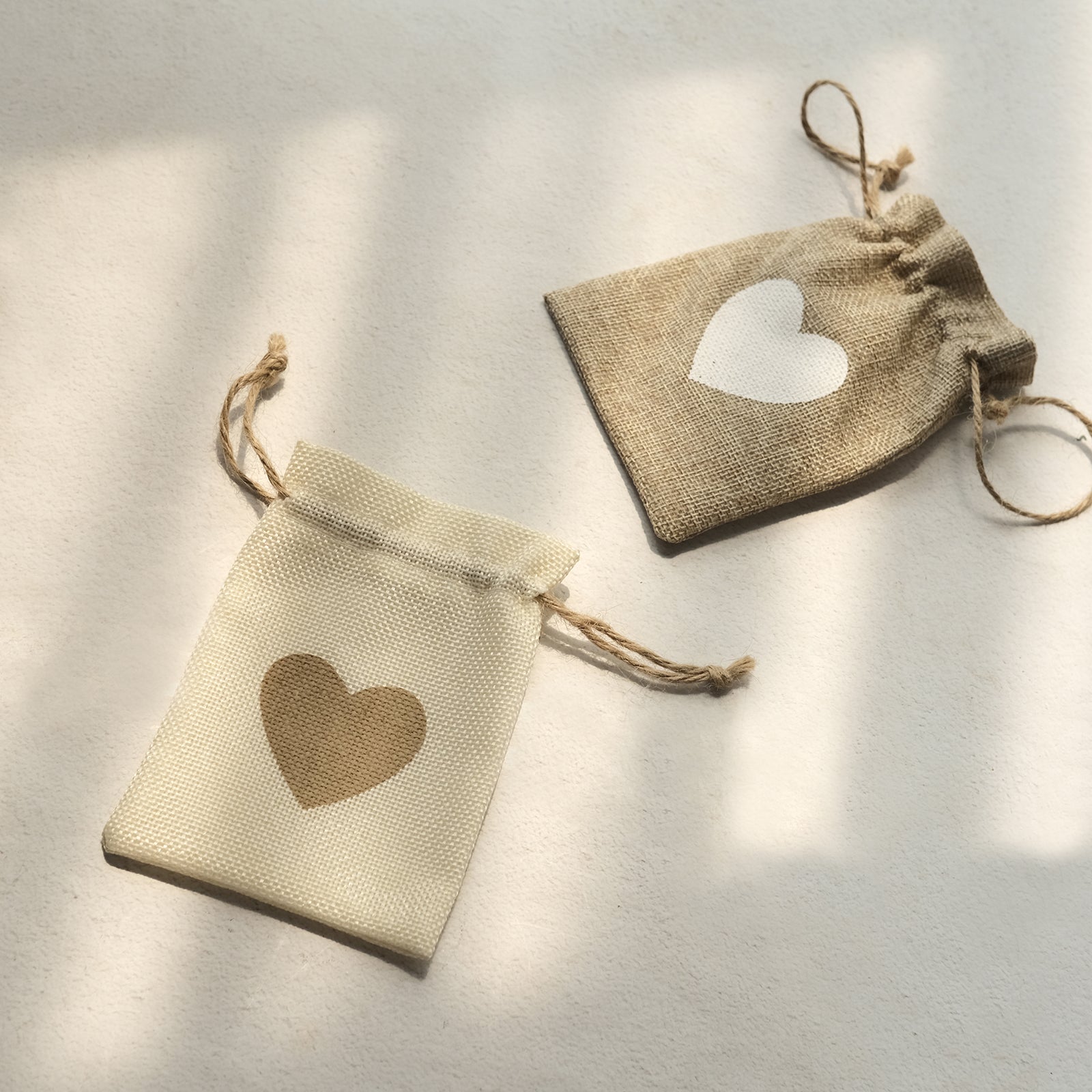 Natural 4"x5" heart design gift bags with drawstring for rustic weddings.