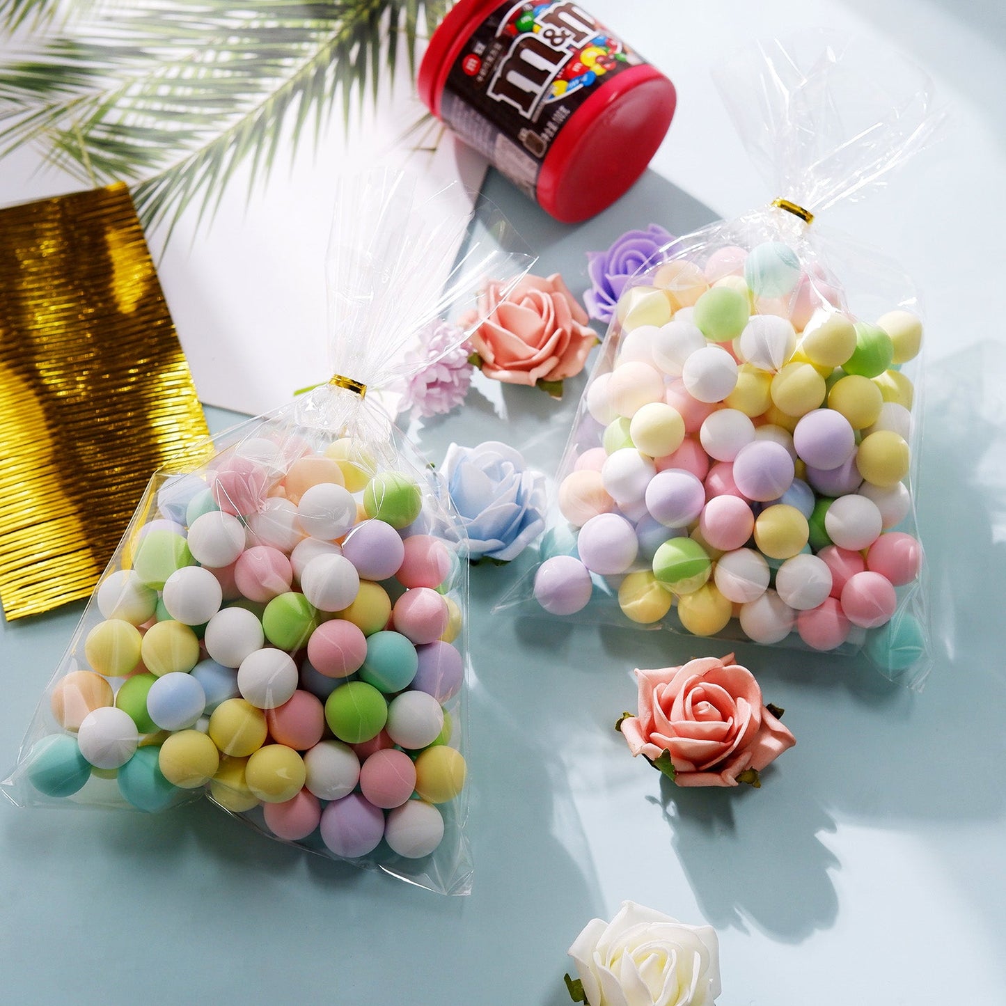 Clear treat bags filled with colorful candy and gold twist ties.