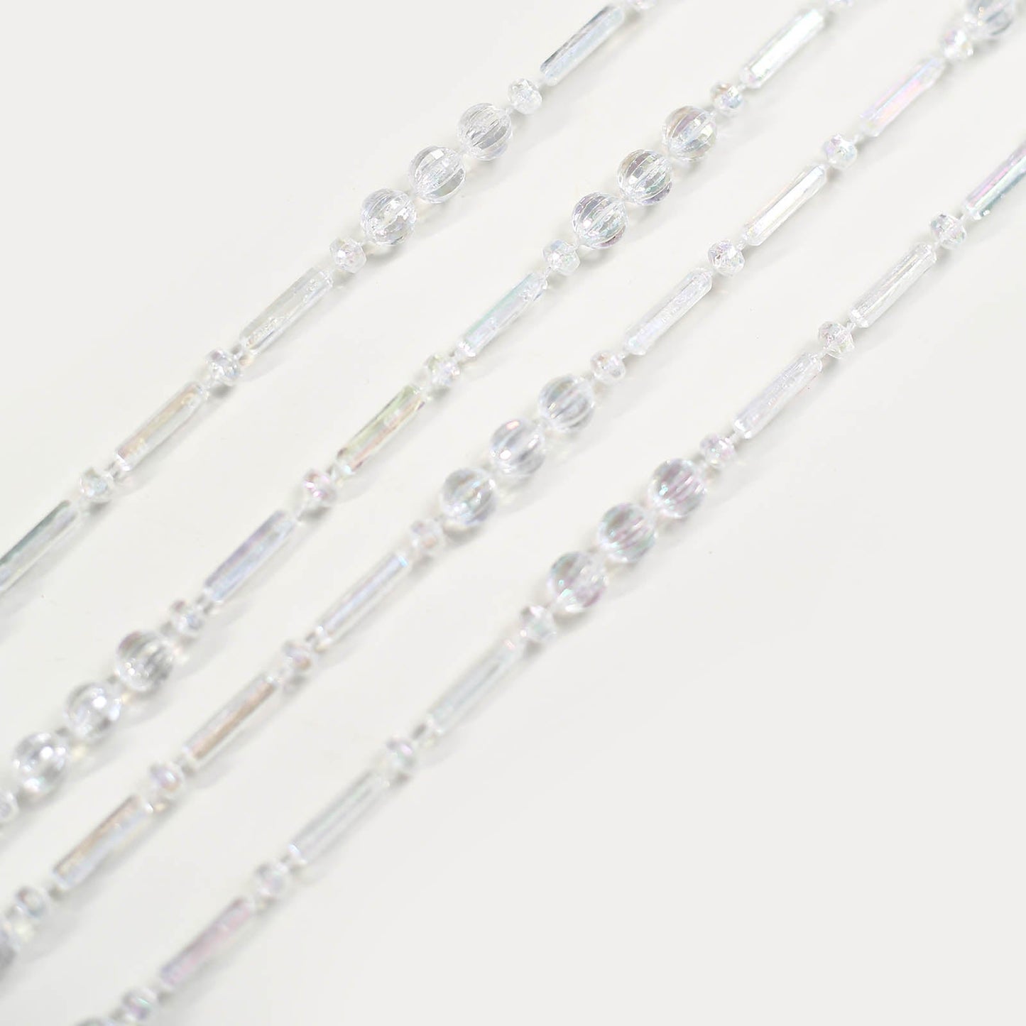 Iridescent pearl beaded chair back garland for wedding decor.