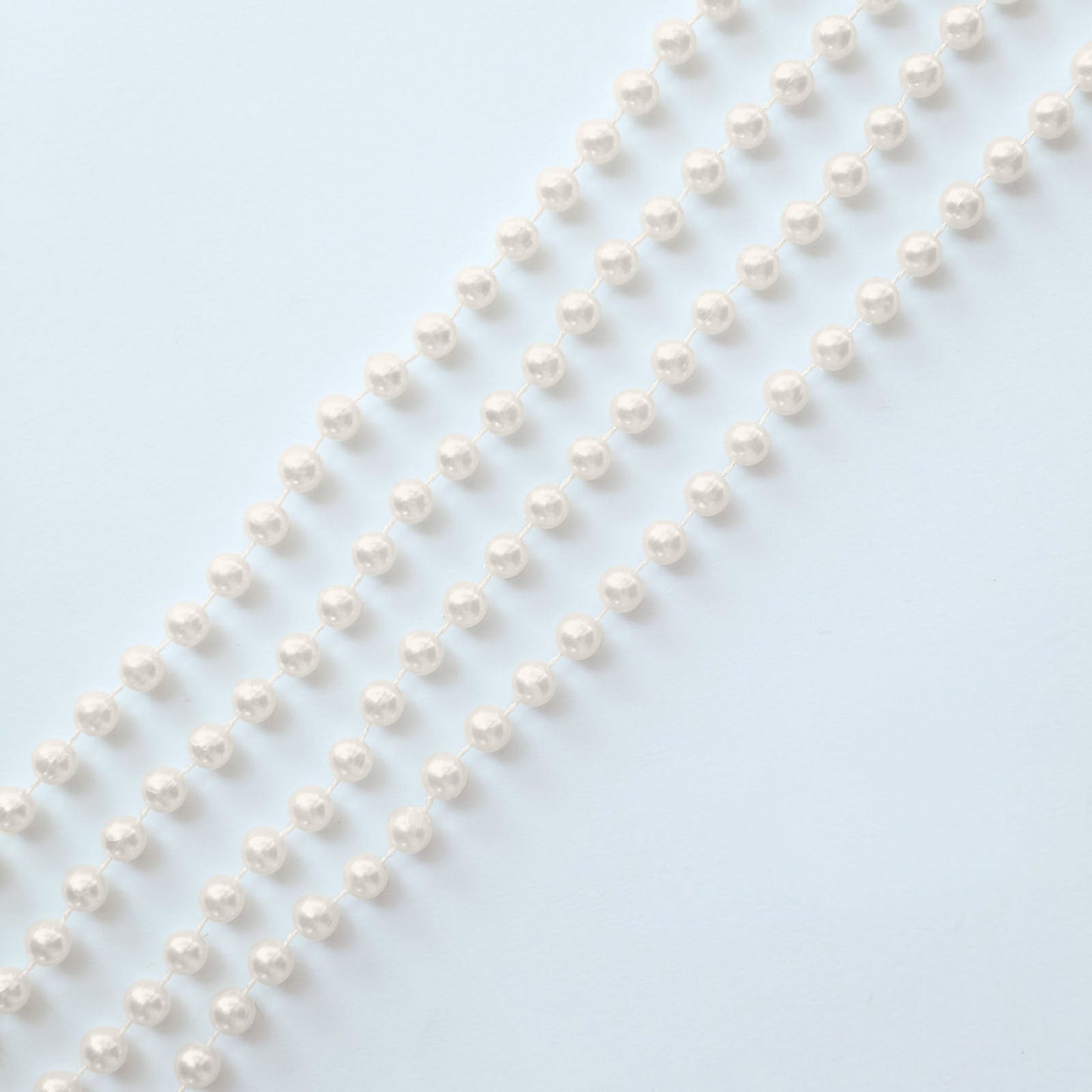 Ivory faux pearl beaded garland for wedding chair decor.